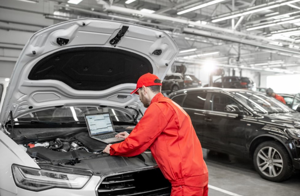 garage automobile technicien capot ouvert ordinateur